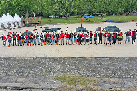 Group photo of the participants of the Apprentice Team Day 2023 in front of their rafts 